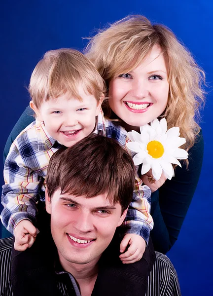 Beautiful young family with baby boy and flower — Stock Photo, Image