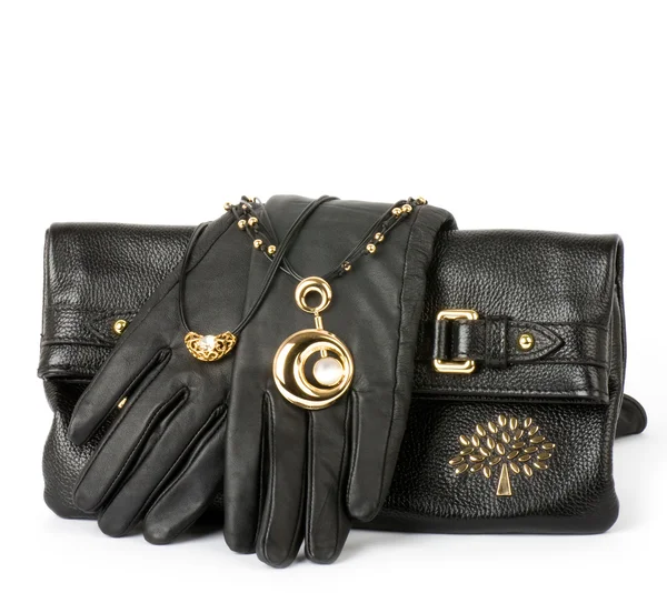 Fashionable handbag, gloves and golden jewelry — Stock Photo, Image