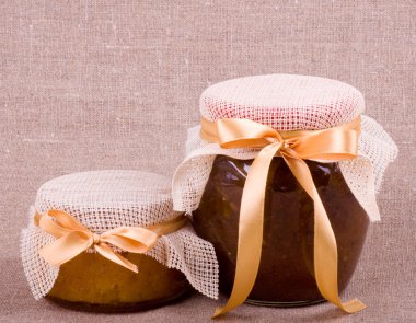 Jars with jam on background clipart