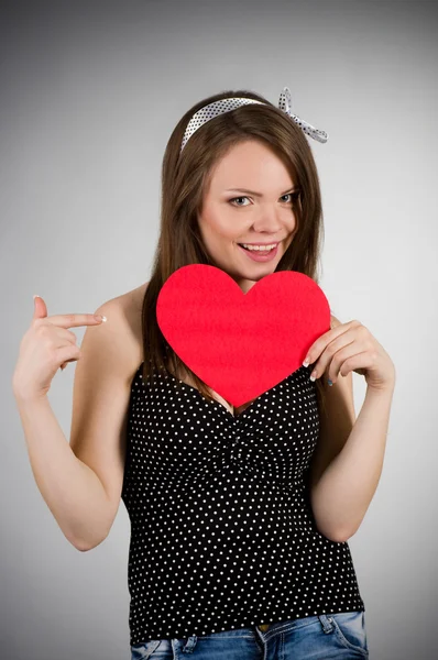 Beautiful young woman with red heart — Stock Photo, Image