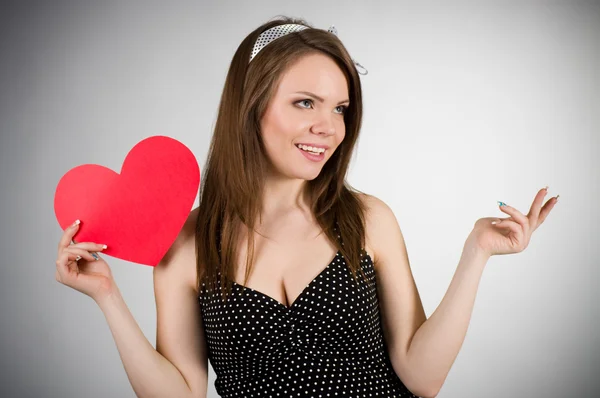 Beautiful young woman with red heart — Stock Photo, Image