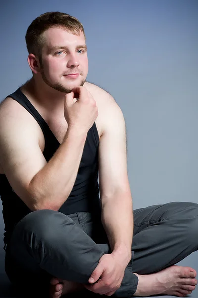 Muskulös ung man på mörk bakgrund — Stockfoto