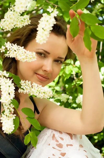 Beautiful woman in spring white flowers — Stock Photo, Image