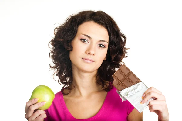 Meisje met apple en chocolade — Stockfoto