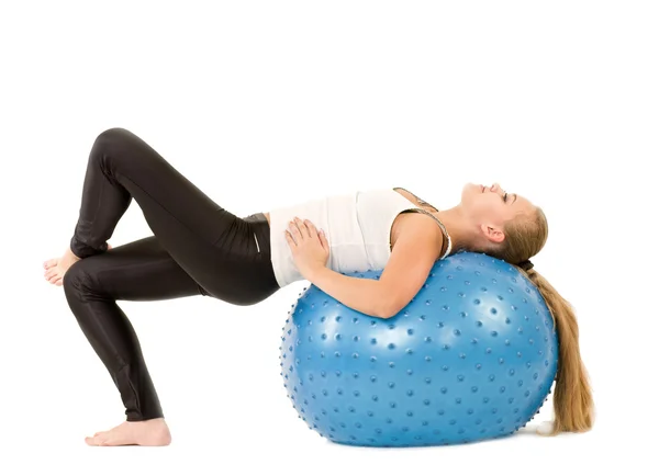 Young woman in gym with a blue ball — Stock Photo, Image