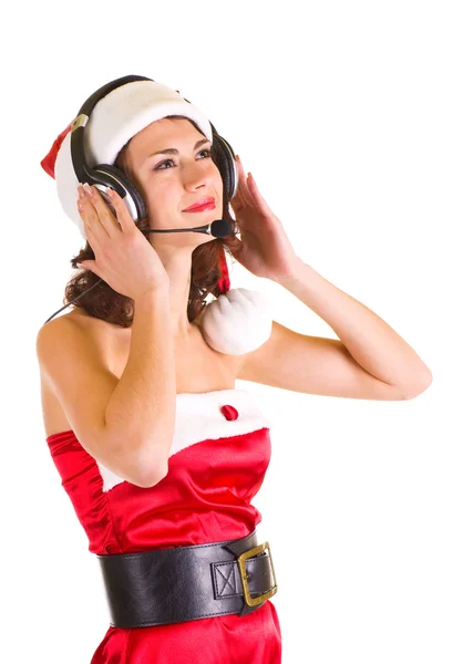Dziewczyna w santa claus ubrania z słuchawki jest do słuchania muzyki — Zdjęcie stockowe
