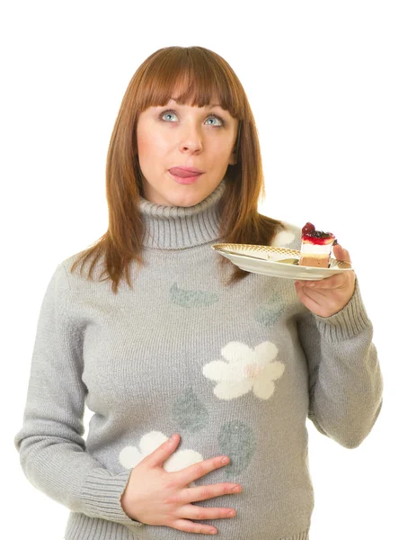 Den vackra unga kvinnan äta läckra tårta — Stockfoto