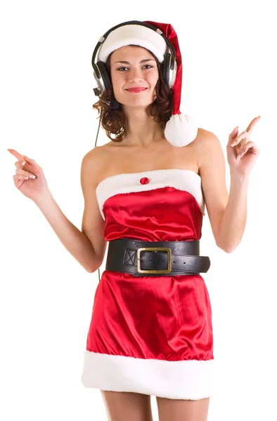 在用耳机的圣诞老人衣服的姑娘是听音乐 — 图库照片