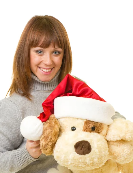 Woman in Santa Claus clothes with toy dog — Zdjęcie stockowe