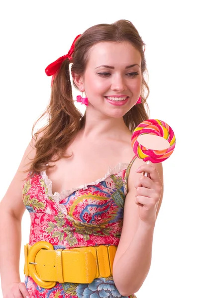 Beautiful young girl with pink spiral lollipops — Stock Photo, Image