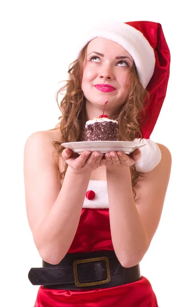 Menina em roupas de Papai Noel com bolo saboroso — Fotografia de Stock