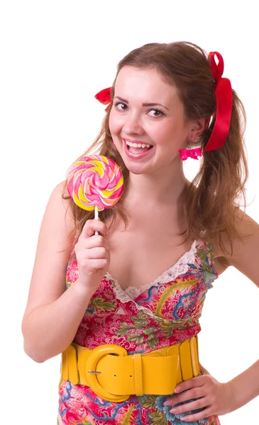 Beautiful young girl with pink spiral lollipops — Stock Photo, Image
