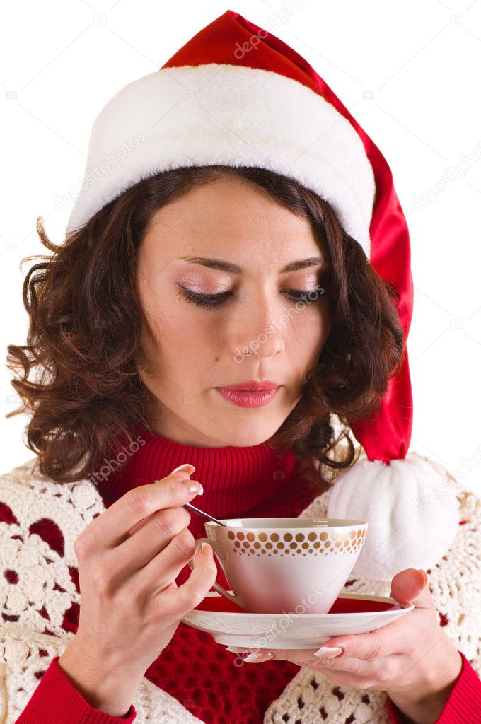 Beautiful young girl in Santa Claus clothes with a cup