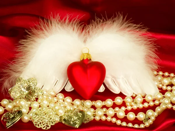 Valentine heart with wings on red background — Stock Photo, Image