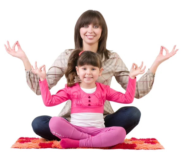Mother and her little daughter embracing in meditation — Stock Photo, Image
