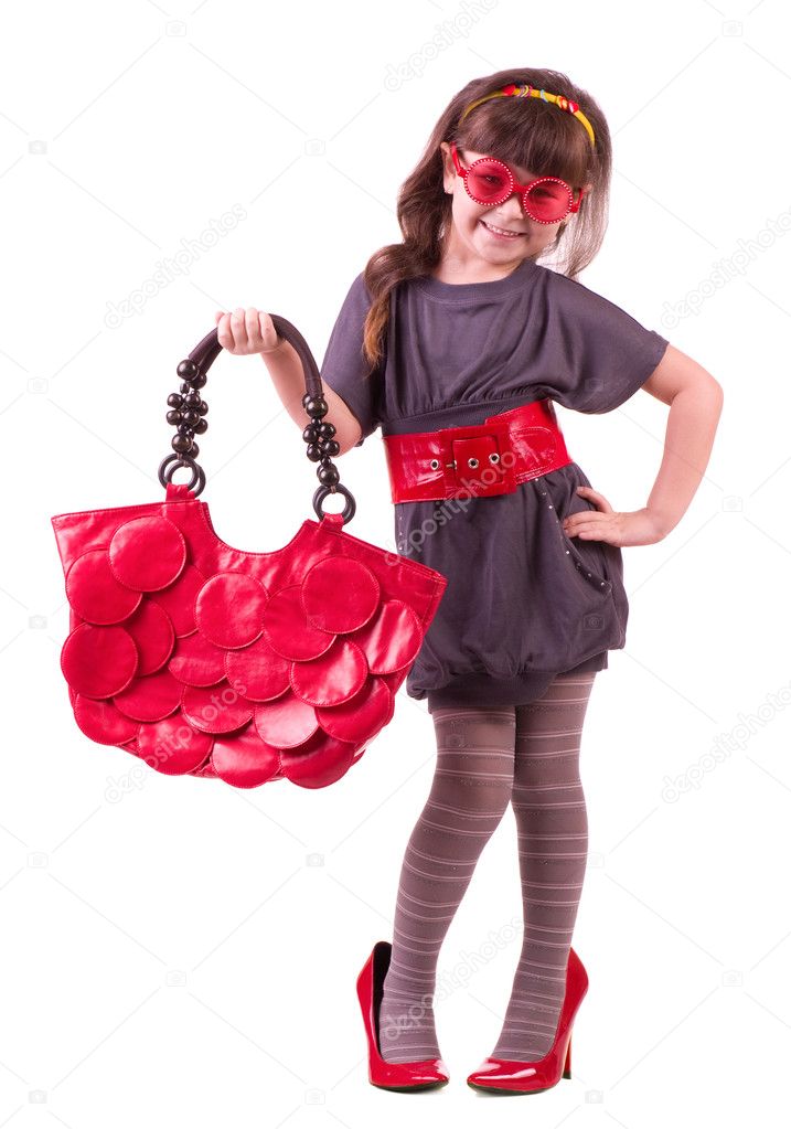 Girl trying on her mother's accessories and shoes
