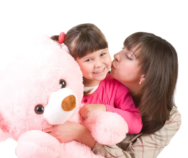 Mother and her little daughter embracing with pink bear — Stock Photo, Image