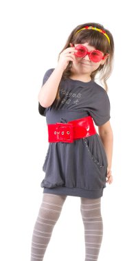 Girl trying on her mother's accessories and shoes clipart