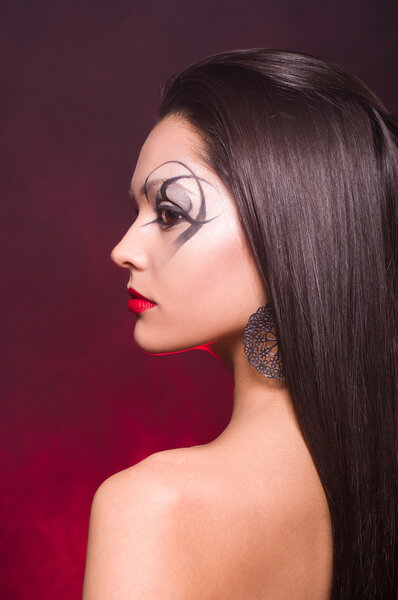 Portrait of a beautiful lady with art makeup