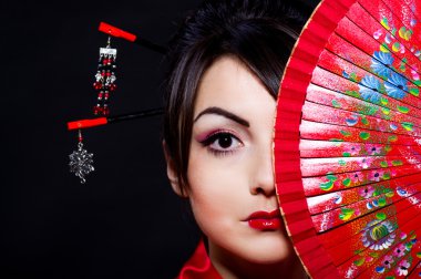 Woman in Asian costume with red Asian fan clipart