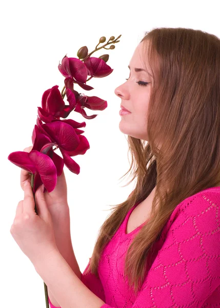 Krásná mladá dívka s orchidejí na bílém pozadí. — Stock fotografie