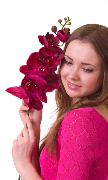 Vacker ung flicka med orkidé på vit bakgrund. — Stockfoto