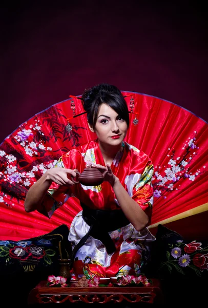 Woman in red Asian costume — Stock Photo, Image