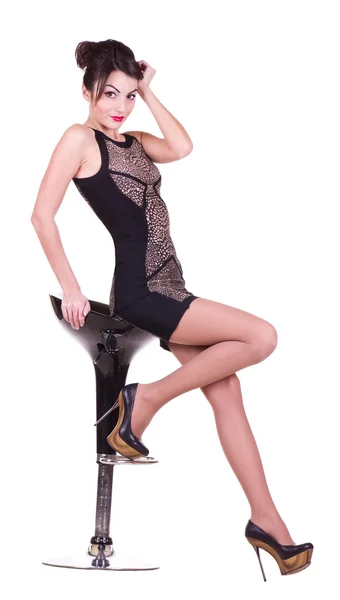 Schöne junge Frau sitzt auf einem Stuhl — Stockfoto