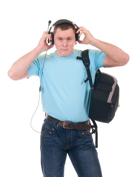 Молодой студент слушает музыку в наушниках — стоковое фото