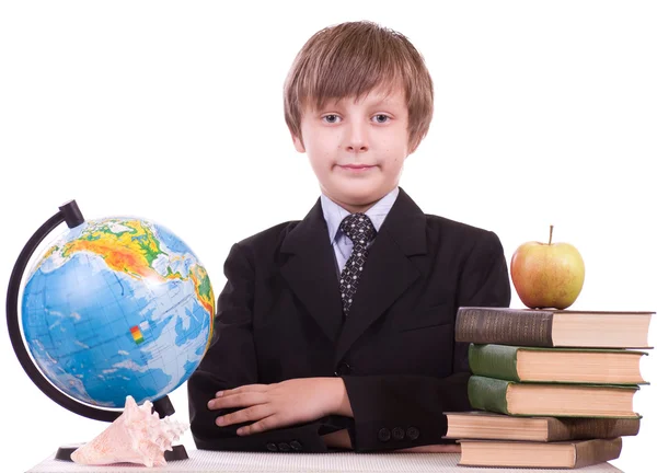 Little schoolboy listens a cockleshell with books — Stock Photo, Image