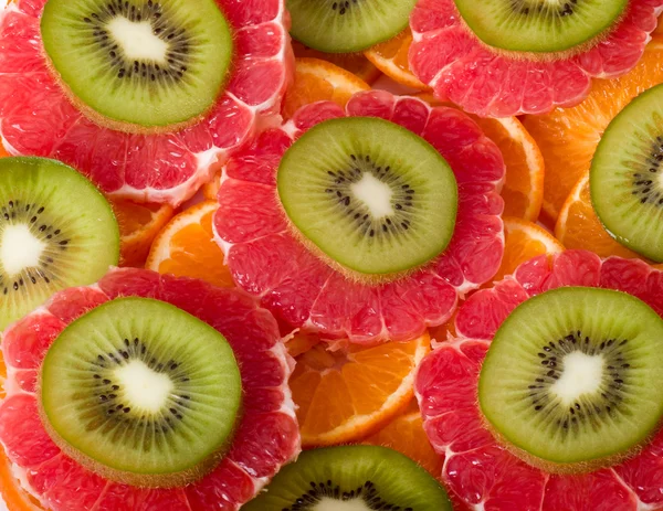 Achtergrond met kiwi, pompelmoes en sinaasappel — Stockfoto