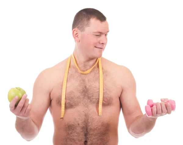Jeune homme avec pomme, haltères et mesure — Photo