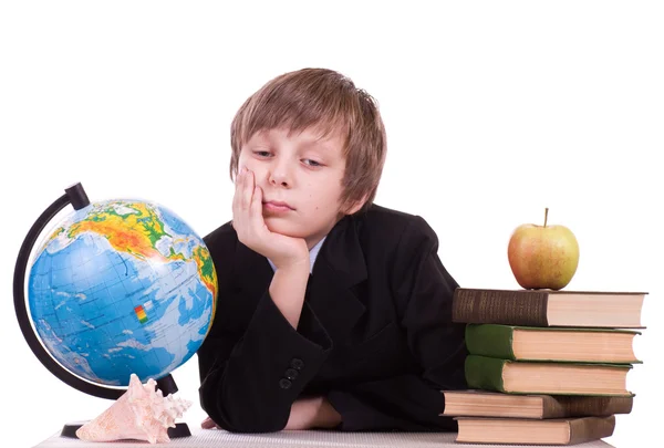 Little schoolboy with globe, books and apple — Stock Photo, Image