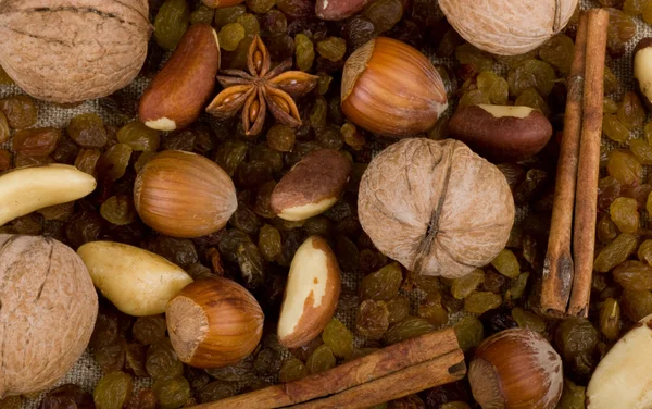 Background with nuts, raisin, cinnamon and spices — Stock Photo, Image