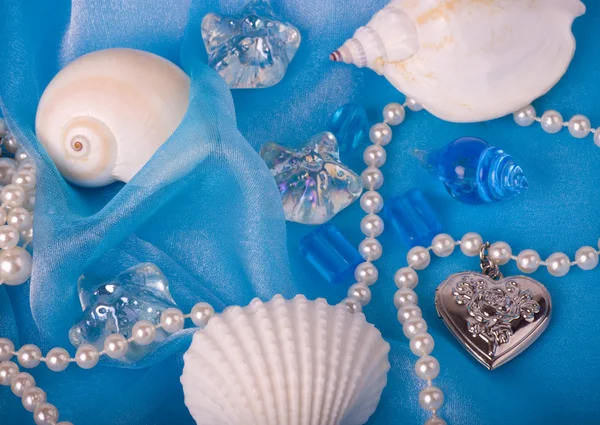 Piękne egzotyczne powłoki i kamienie, perły na niebieskie tło — Zdjęcie stockowe