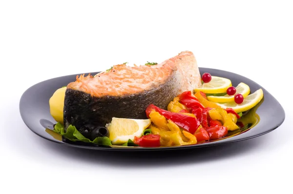 Salmón frito con verduras a la parrilla en un plato negro — Foto de Stock