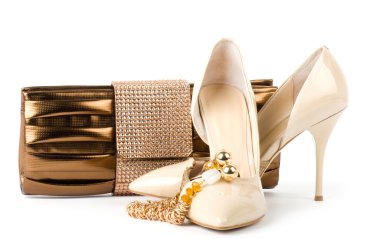 Sexy fashionable shoes with handbag and golden jewelry on white background. clipart