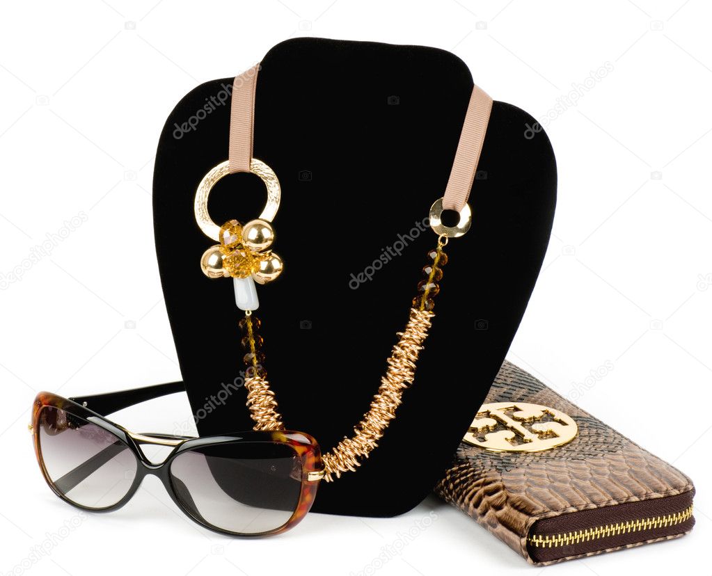 Fashionable handbag and golden jewelry, glasses on white background.