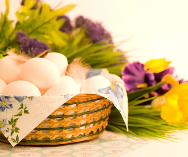 Mand met Pasen eieren en Lentebloemen op witte achtergrond — Stockfoto