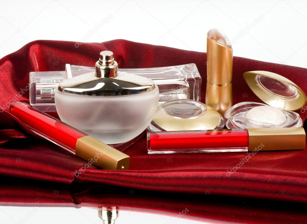 Perfume bottles, red lipstick and eyeshadow