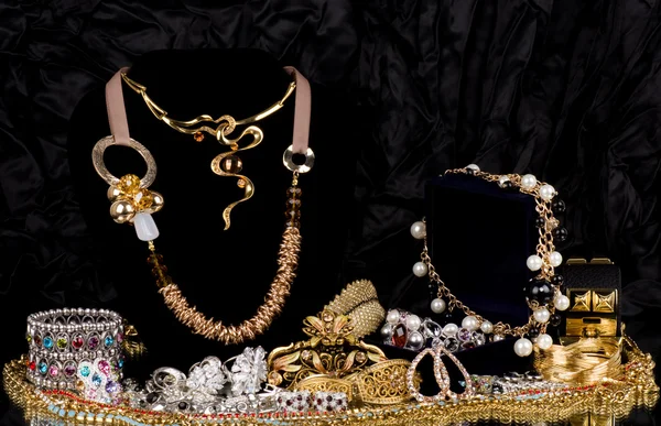 Golden jewelry on black background — Stock Photo, Image