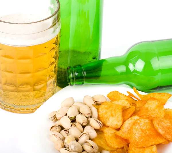 Potato chips and pistachios with beer on white — Stock Photo, Image