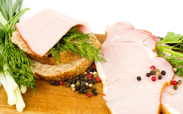 Ham on wooden platter with spices — Stock Photo, Image