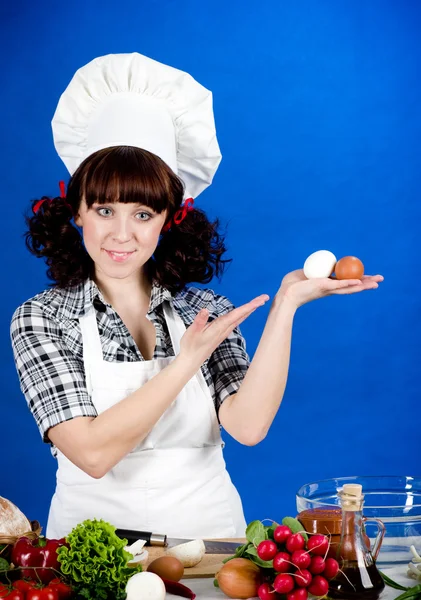 Smiling happy cook woman holds a easter eggs — Stock Photo, Image