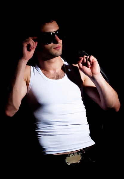 Fashionable muscular man in a fashion pose — Stock Photo, Image