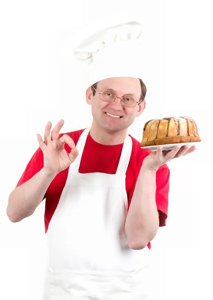 Üniforma ve çikolatalı kek pasta ile şapka erkek aşçı — Stok fotoğraf