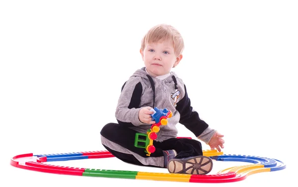 Toddler boy playing with a toy train — Stock Photo, Image