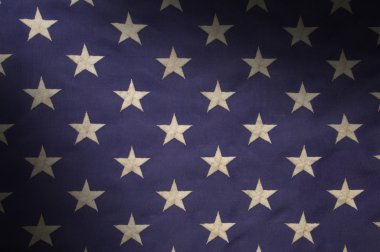 Stars in a field of blue on an American flag lit diagonally clipart