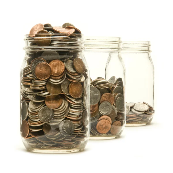 Three glass jars filled with American coins — Stock Photo, Image
