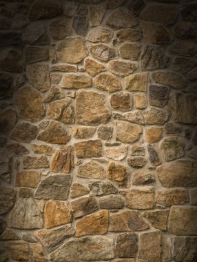 Brown masonry rock wall lit dramatically clipart